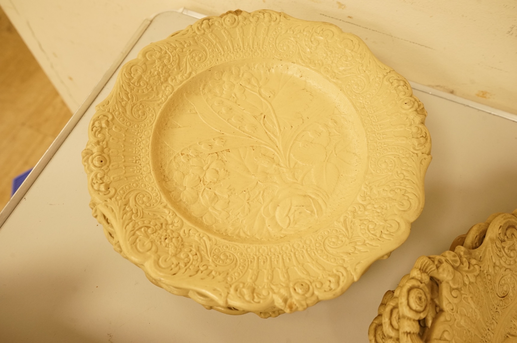 A Victorian drabware part dessert set, comprising eleven plates and three two handled dishes, dishes 25cm wide